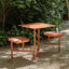 Outdoor picnic table with aluminum frame and colorful white, light green, and orange top