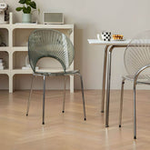 Stackable Scandinavian style dining chair with plastic seat, acrylic back, and silver legs main product image