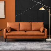 Minimalist grey sofa with tangerine accents