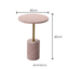 Pink terrazzo coffee table with gold accents in a modern minimalist design