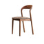 Brown leather dining chair with a modern curved back and simplistic design, single piece