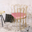 Pink velvet upholstered accent chair with luxurious gold legs