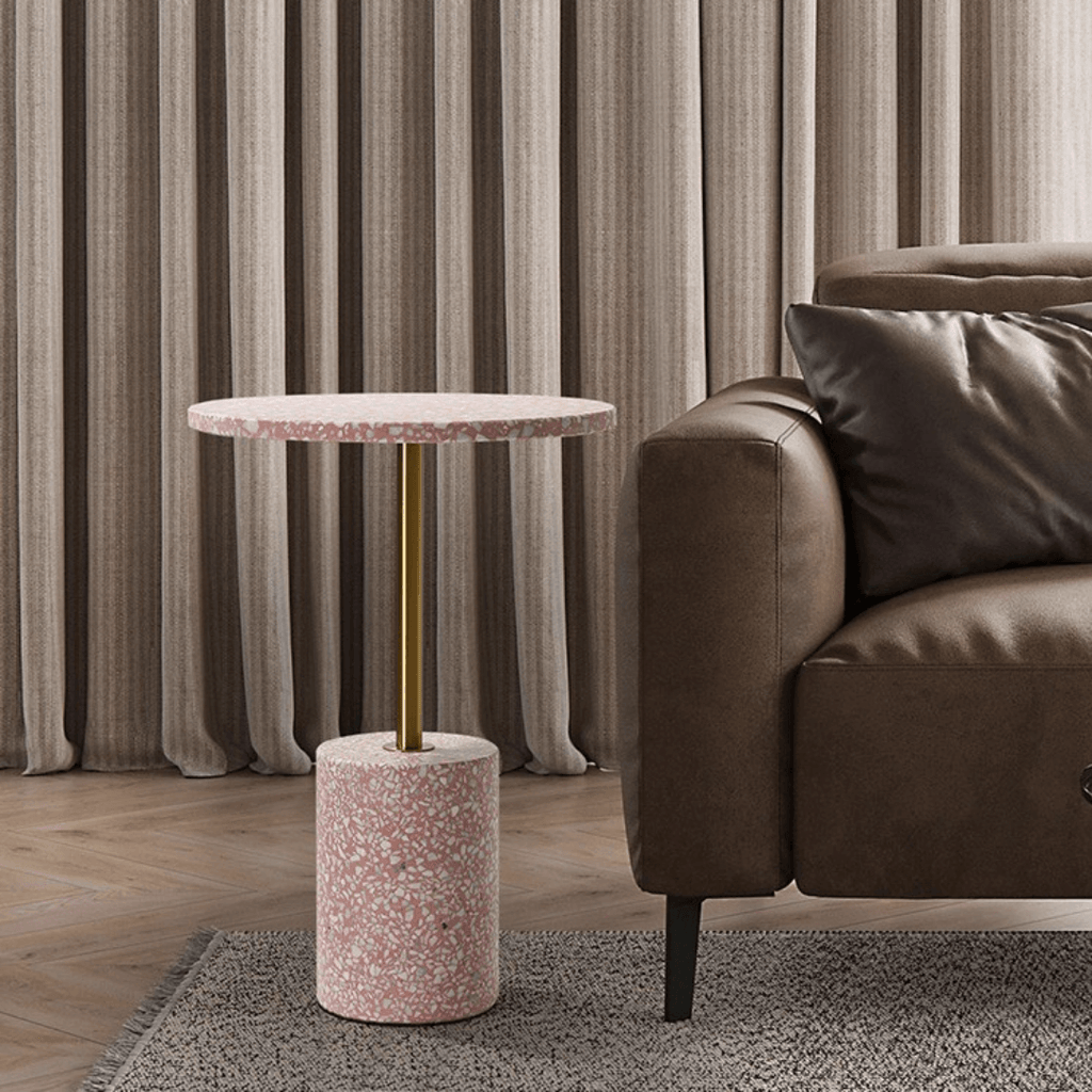 Pink terrazzo coffee table with gold accents in a modern minimalist design
