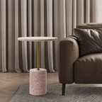 Pink terrazzo coffee table with gold accents in a modern minimalist design