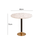 Rattan dining chairs with durable terrazzo table for an elegant dining setup