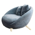 Scandinavian papasan chair with fixed back, sloped arms, cotton blend fabric, and 2 pillows