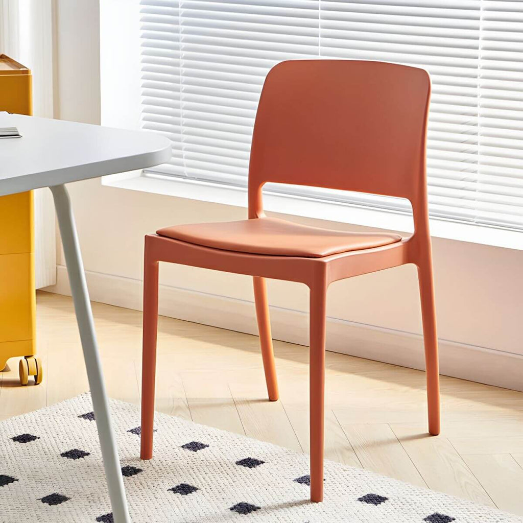 Scandinavian plastic and acrylic dining chair with low backrest and armless design