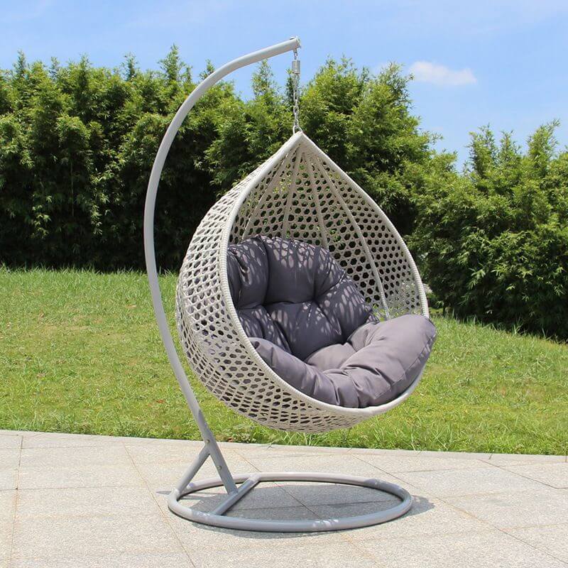 Metal porch swing with stand, cushions, and chain for comfortable outdoor seating