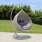 Metal porch swing with stand, cushions, and chain for comfortable outdoor seating