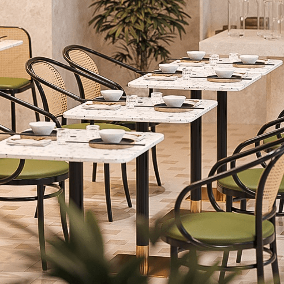 Rattan dining chairs with durable terrazzo table for an elegant dining setup