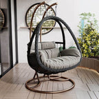 Tropical porch swing with corrosion-resistant cushions, alloy chain, and sturdy stand included
