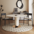 Round terrazzo dining table featuring a stylish wooden and metal base for elegant interiors