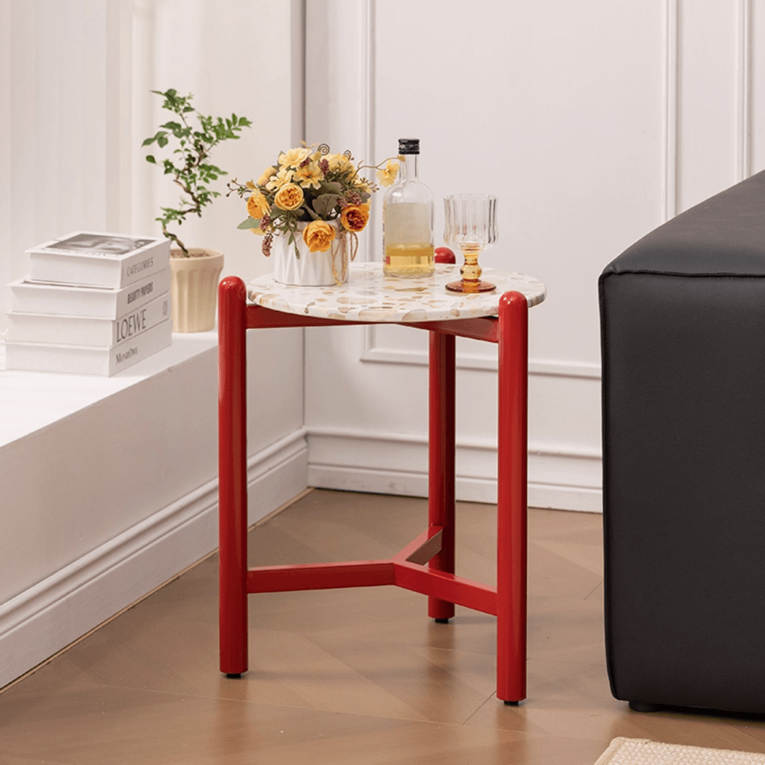 Round side table with vibrant red terrazzo top, featuring a modern minimalist design