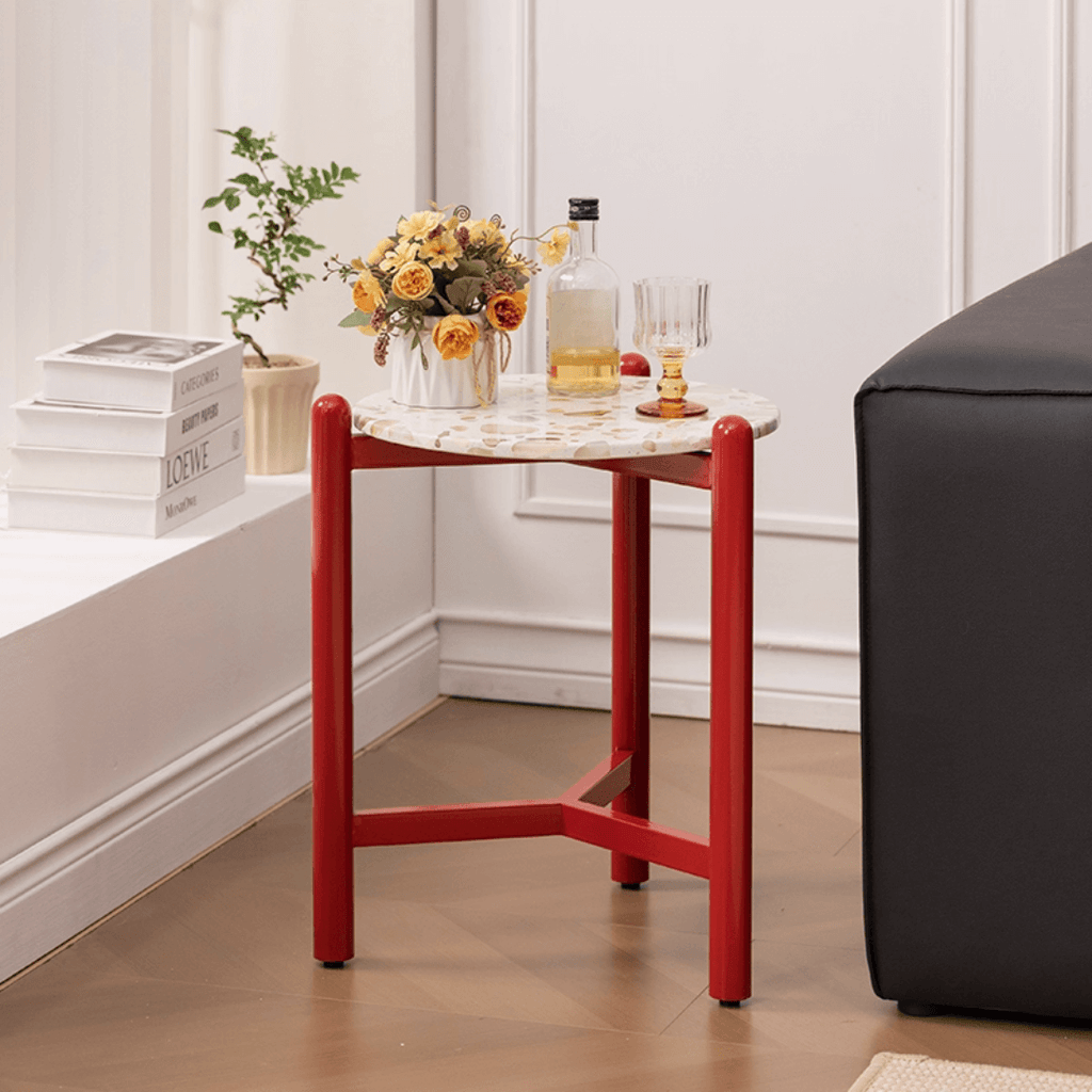 Round side table with vibrant red terrazzo top, featuring a modern minimalist design