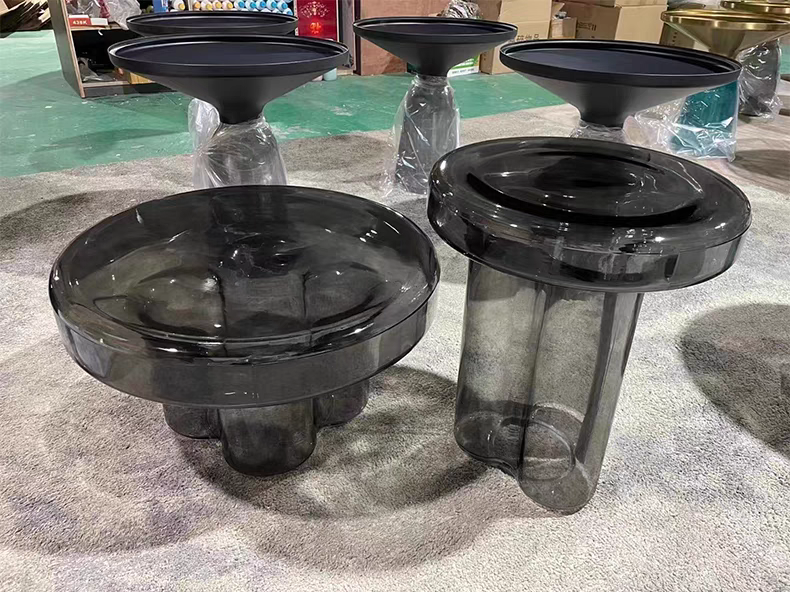 Cloud-shaped modern glass coffee table set with two pieces in vibrant orange, green, purple, and black