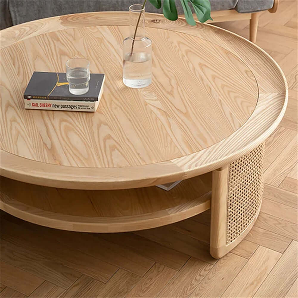 Round Japandi coffee table with solid wood top and rattan base, featuring two tiers for storage