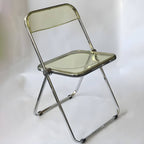 Scandinavian style dining chair with silver metal legs and plastic acrylic seat