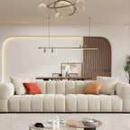 Beige upholstered wood sofa with square arms and sewn pillow back for modern living rooms