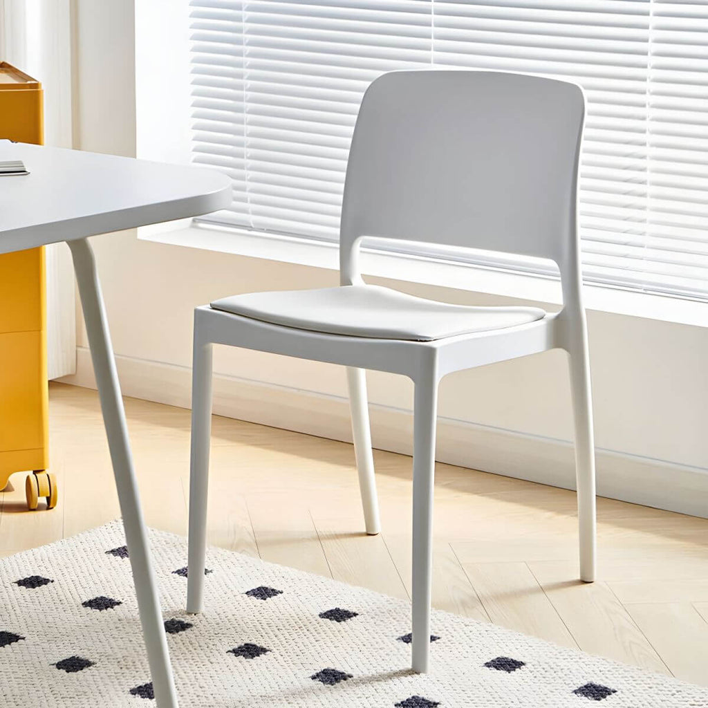 Scandinavian plastic and acrylic dining chair with low backrest and armless design