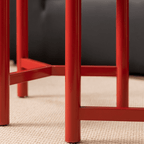 Round side table with vibrant red terrazzo top, featuring a modern minimalist design