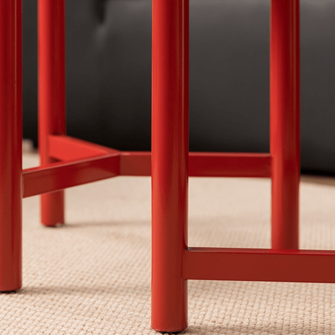 Round side table with vibrant red terrazzo top, featuring a modern minimalist design