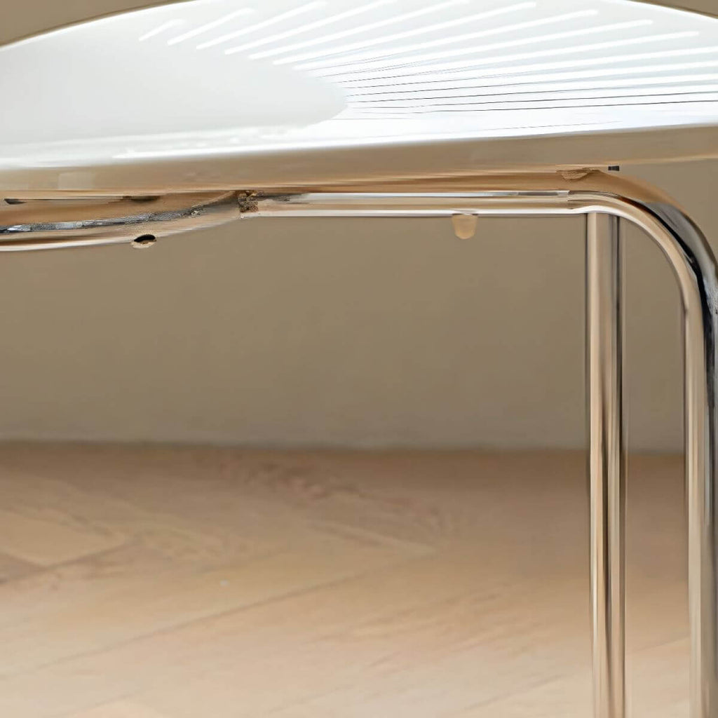 Stackable Scandinavian style dining chair with plastic seat, acrylic back, and silver legs