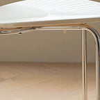 Stackable Scandinavian style dining chair with plastic seat, acrylic back, and silver legs