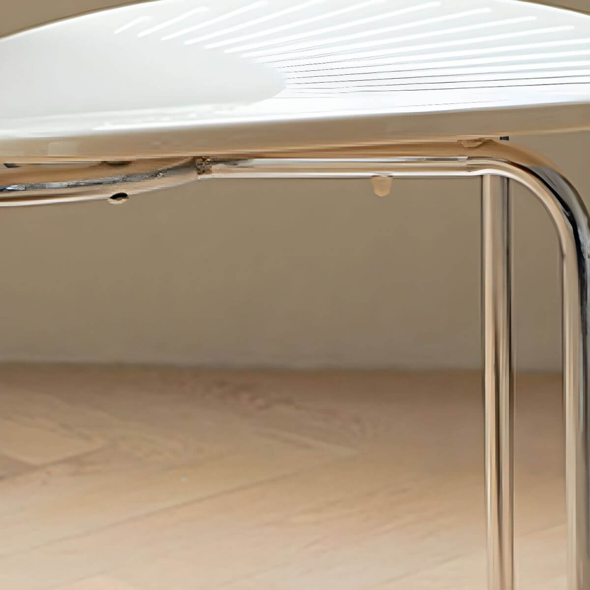 Stackable Scandinavian style dining chair with plastic seat, acrylic back, and silver legs