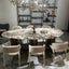Oval marble dining table with white top and three gold steel legs