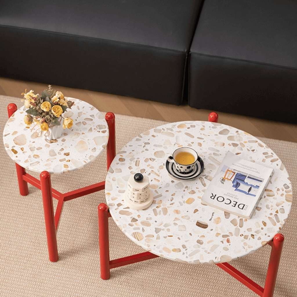 Round side table with vibrant red terrazzo top, featuring a modern minimalist design