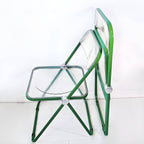 Contemporary acrylic folding armless chair with open back, ideal for dining rooms