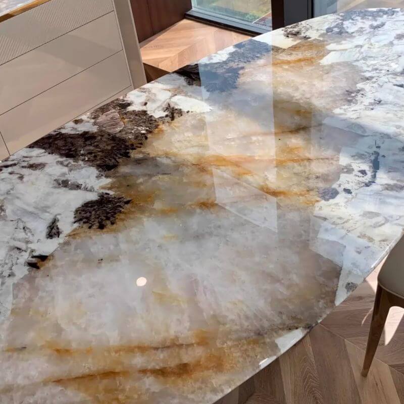 Elliptical white marble effect dining table with anti-stain and scratch-tolerant finish, seats 6 to 8