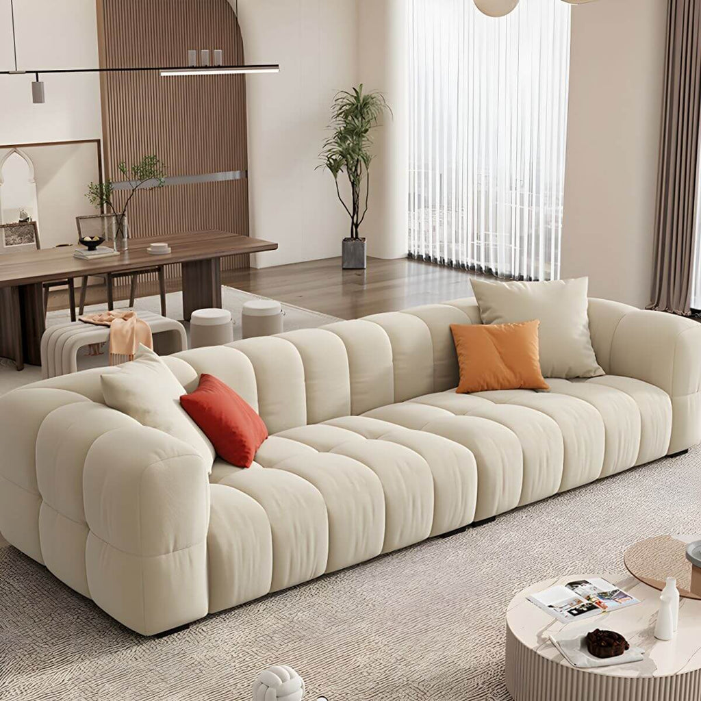 Beige upholstered wood sofa with square arms and sewn pillow back for modern living rooms