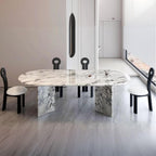 Oval dining table with white marble top and fixed base, perfect for contemporary dining rooms