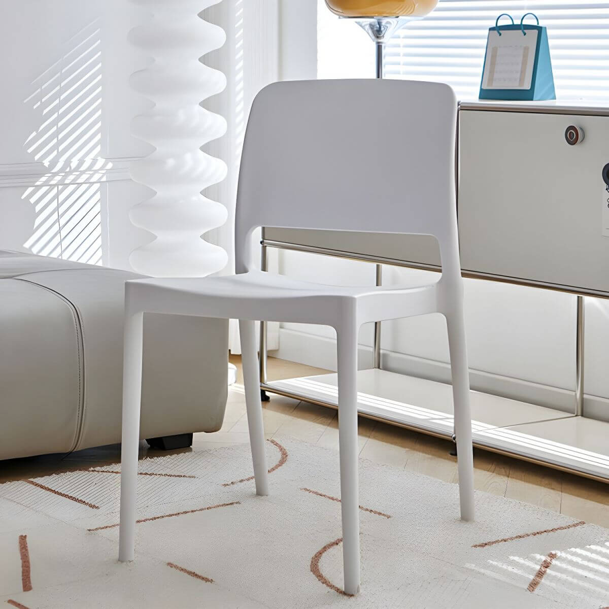 Scandinavian plastic and acrylic dining chair with low backrest and armless design