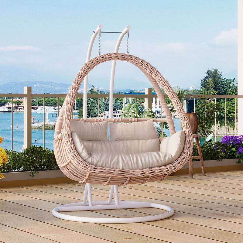Pink metal 2-seater porch swing with stand, chain, and cushions for outdoor seating