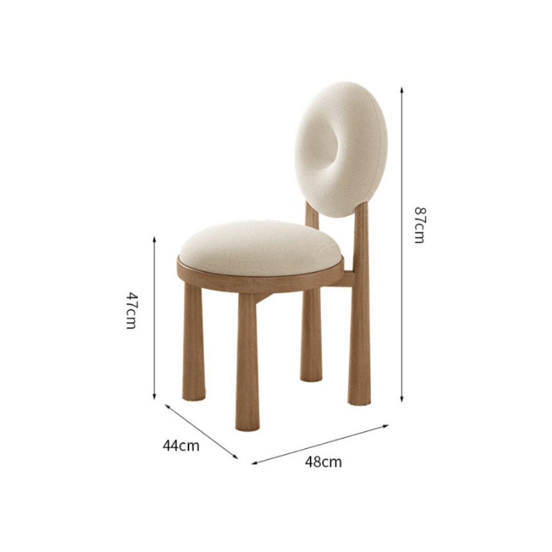 Round terrazzo dining table with soft wool upholstered chairs for a trendy home setup