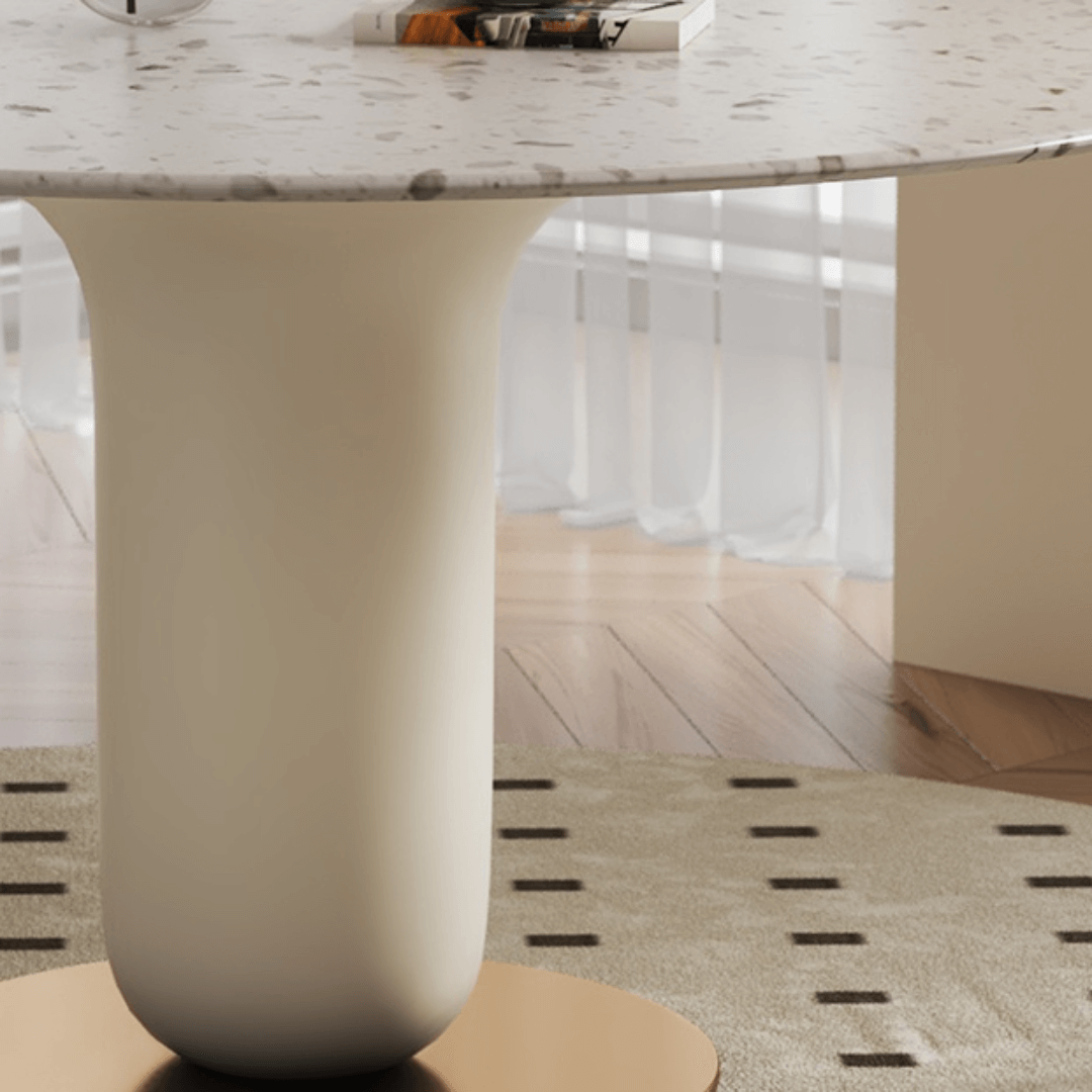 Round terrazzo dining table featuring a stylish wooden and metal base for elegant interiors