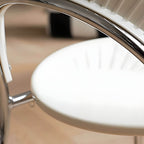 Stackable Scandinavian style dining chair with plastic seat, acrylic back, and silver legs