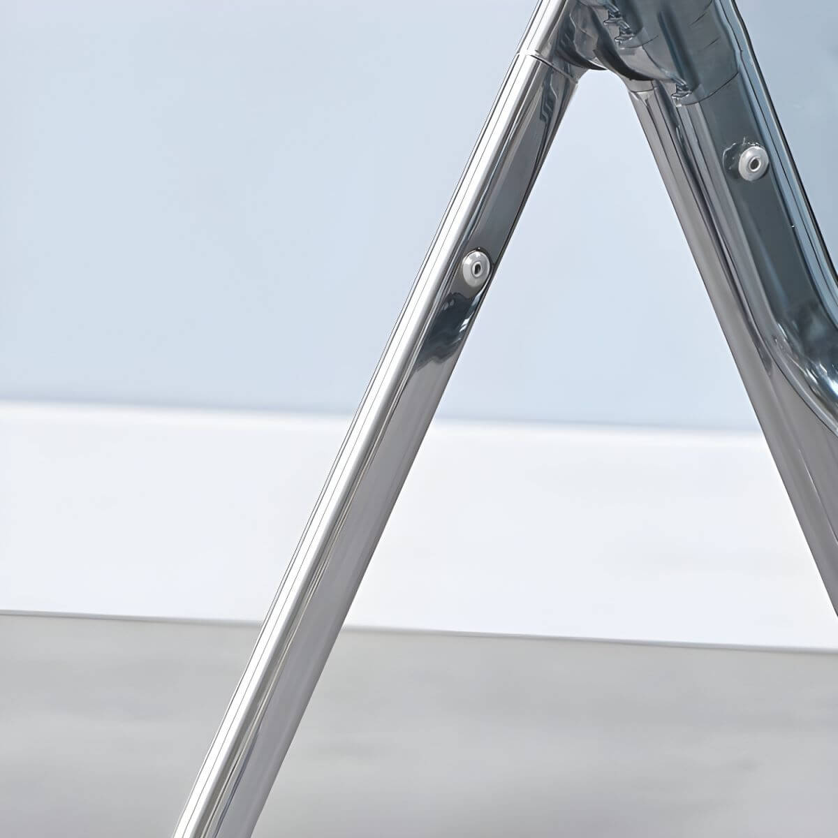 Scandinavian style dining chair with silver metal legs and plastic acrylic seat