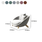 Scandinavian papasan chair with fixed back, sloped arms, cotton blend fabric, and 2 pillows