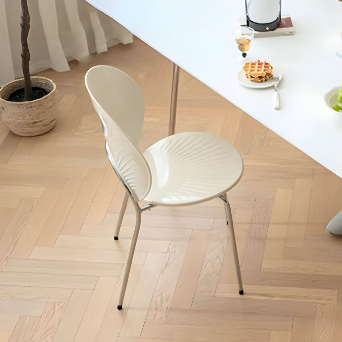 Stackable Scandinavian style dining chair with plastic seat, acrylic back, and silver legs