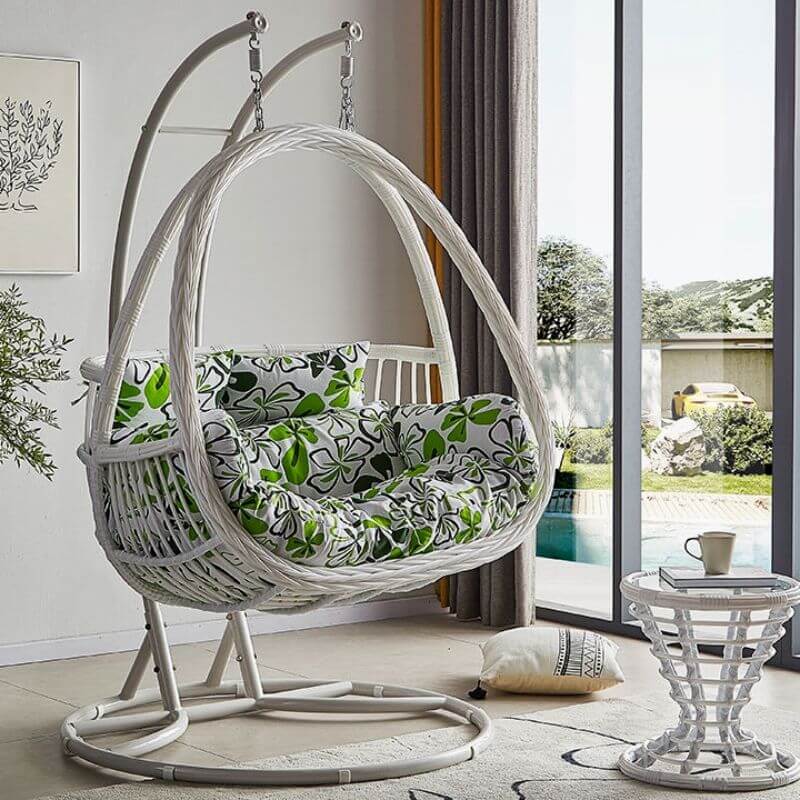 Tropical porch swing with corrosion-resistant cushions, alloy chain, and sturdy stand included