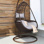Metal porch swing with tropical olive green, auburn, and rose cushions, includes stand and chain