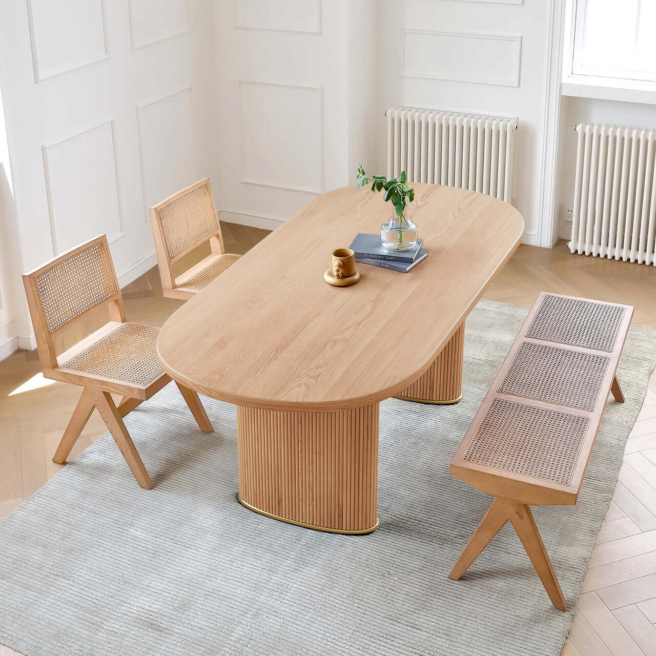 Oval dining table made of solid ash wood with a smooth finish, perfect for modern dining rooms