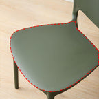 Scandinavian plastic dining chair with open back and four legs, ideal for home use