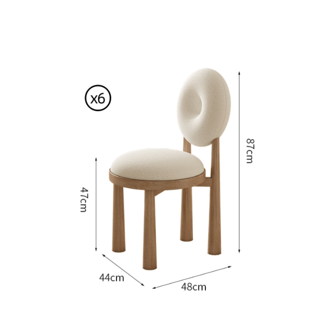 Round terrazzo dining table with soft wool upholstered chairs for a trendy home setup