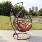 Metal porch swing with stand, cushions, and chain for comfortable outdoor seating