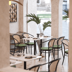 Rattan dining chairs with durable terrazzo table for an elegant dining setup