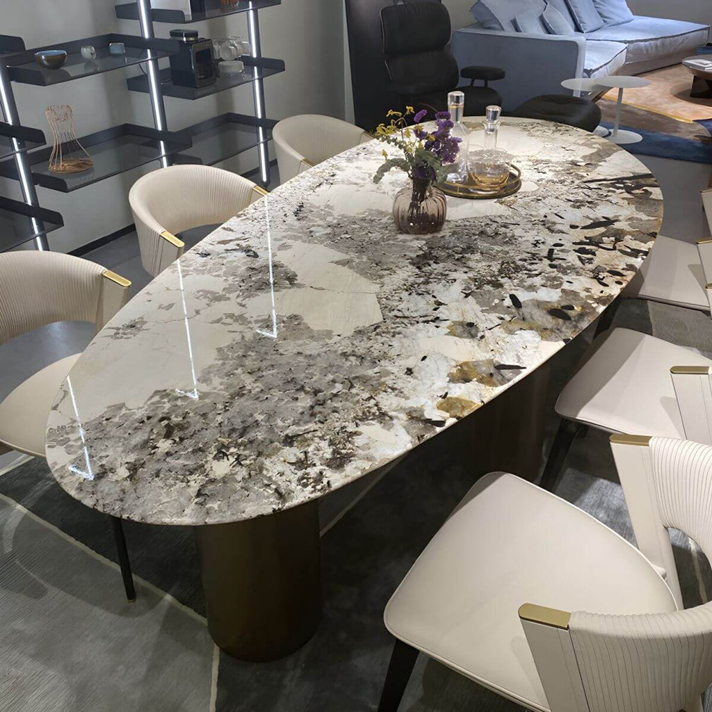 Oval marble dining table with white top and three gold steel legs main product image